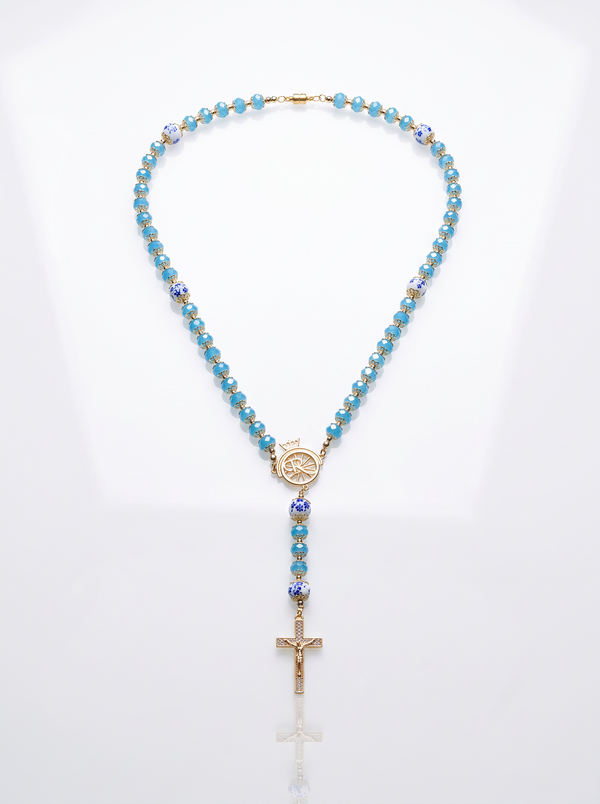 Ave Maria Nomads | Rad | Türkisfarbener Rosenkranz mit dunkelblauen Perlen – vergoldetes ROLLEMAN-Logo mit Kreuz und Magnetverschluss