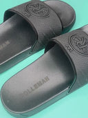 BlackEssenceSlides: Black slippers with a ROLLEMAN wheel and a repeated ROLLEMAN pattern 
