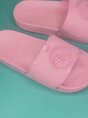 PinkGlowSlides: Pink slippers with a ROLLEMAN wheel and a repeating ROLLEMAN pattern 