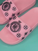 Nerina Slides: Pink slippers with a ROLLEMAN wheel and a black floral pattern. 