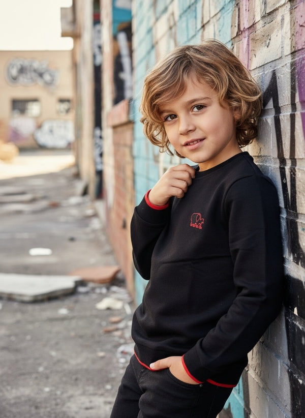 Sweater Tjabo - Kinder, schwarz mit fluoreszierenden orangefarbenen Akzenten