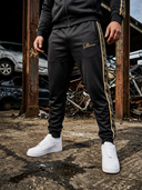 ROLLEMAN Ravi Trainingsbroek – Zwart / Amber Goud